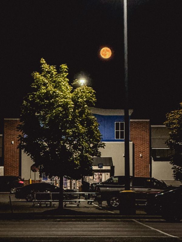 Moon over the parking lot — from Graveyard Shift. Photograph by Isaiah Sanchez.