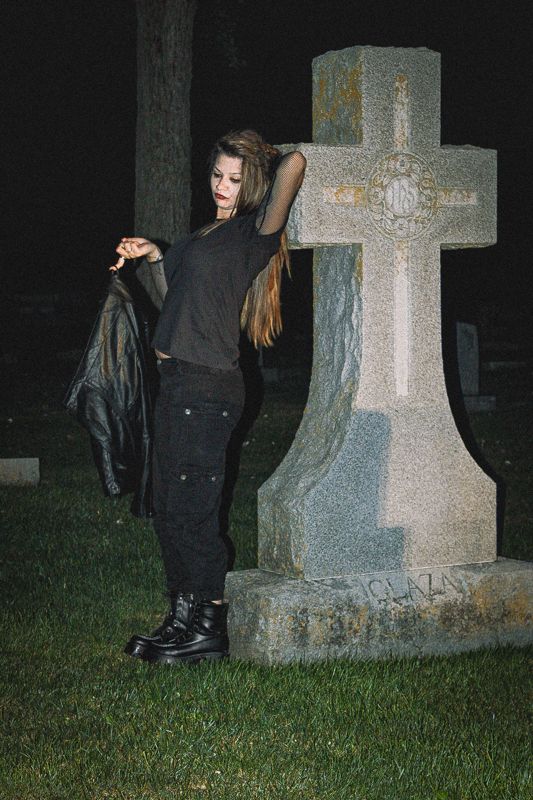 Draped at the stone — from Graveyard Shift. Photograph by Isaiah Sanchez.
