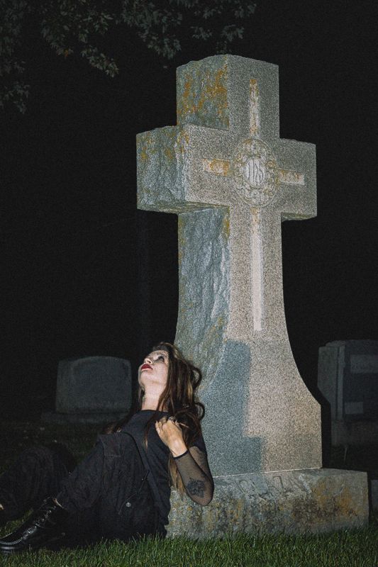 Seated at the grave — from Graveyard Shift. Photograph by Isaiah Sanchez.